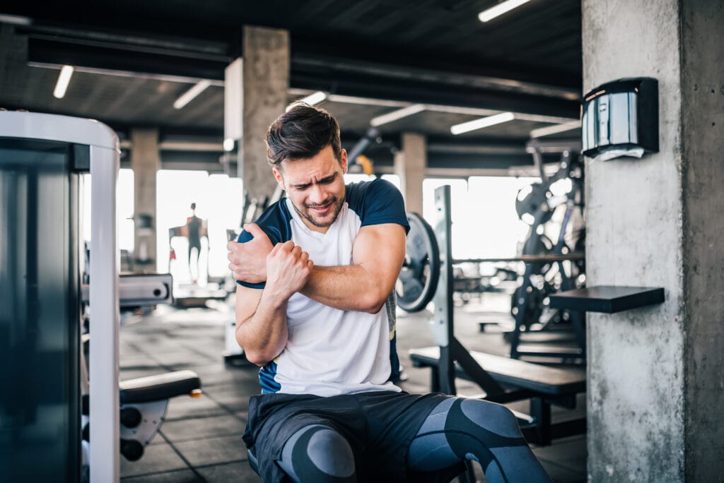 Man holding his hurt shoulder