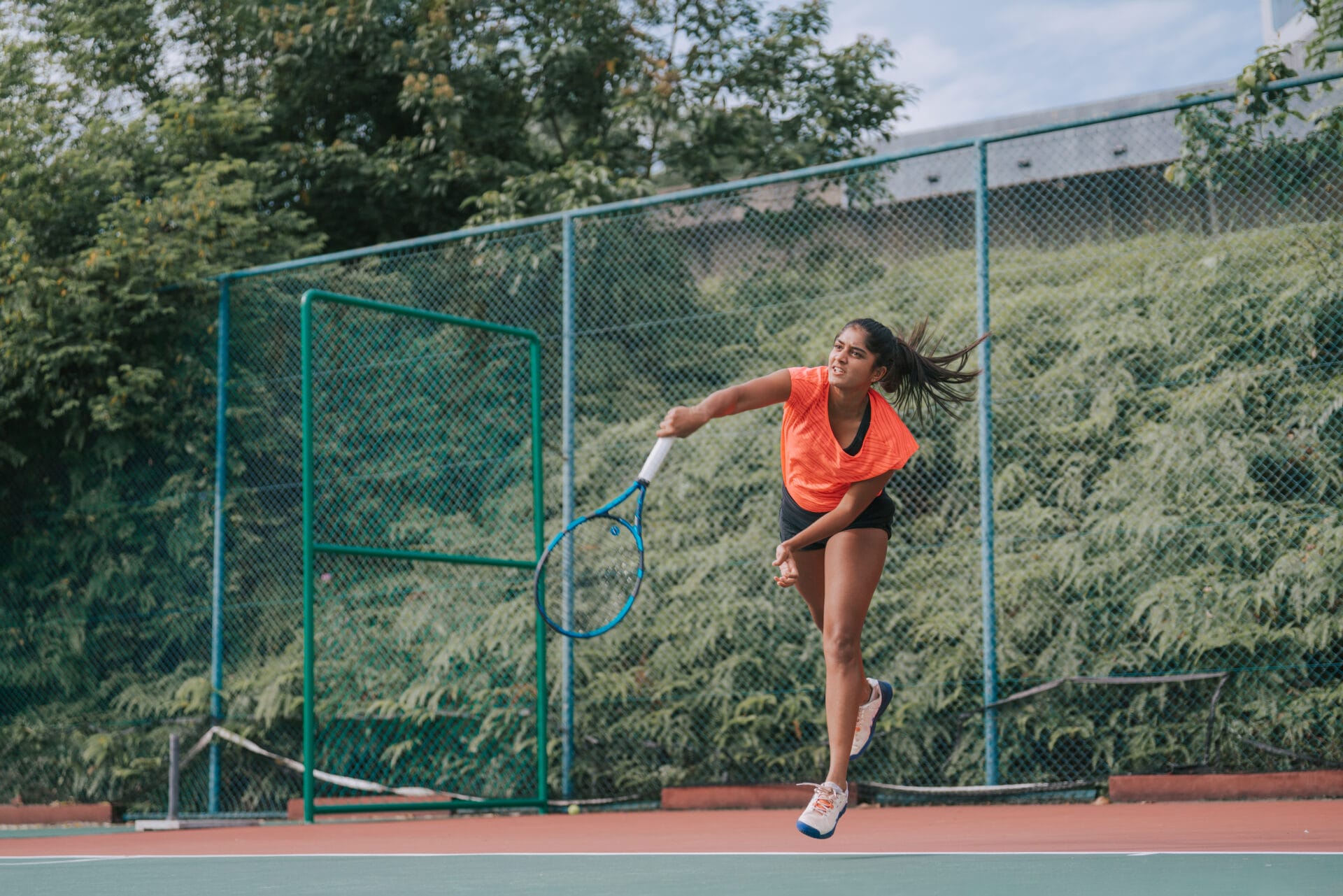 Woman playing tennis in the spring